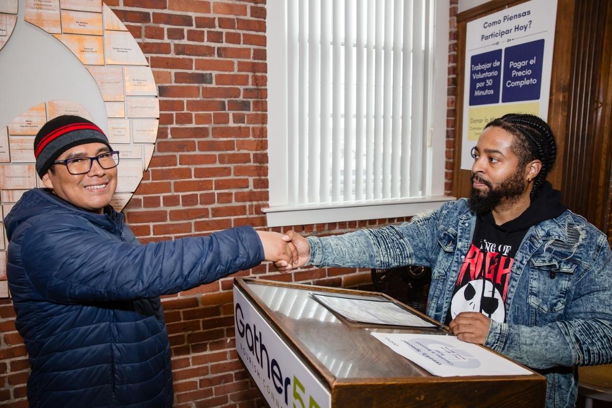 A Guest and the Gather55 greeter shaking hands