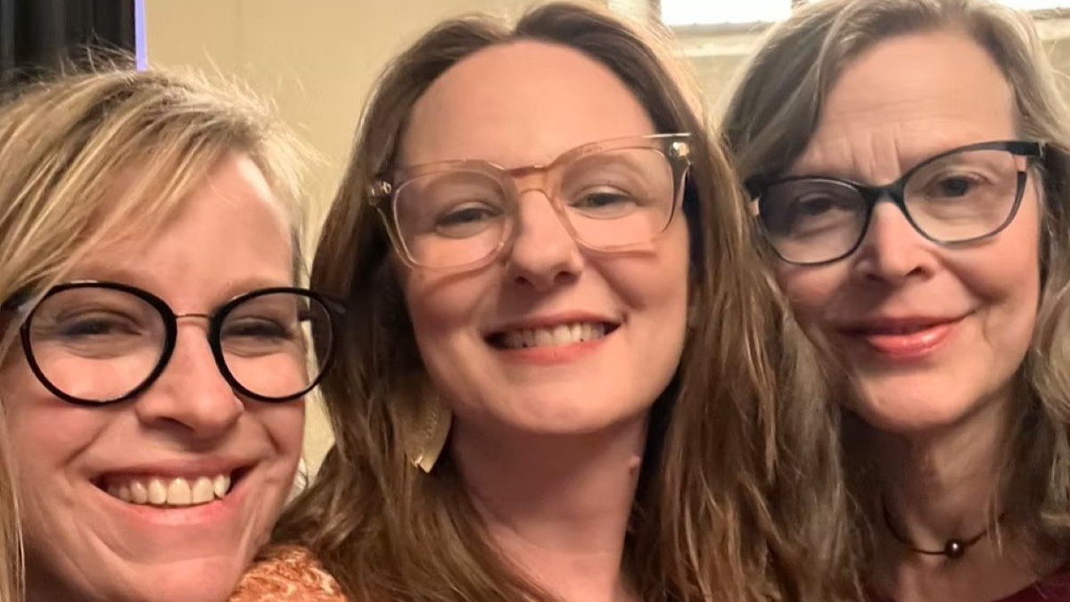 IN TRINE musicians smiling at the camera